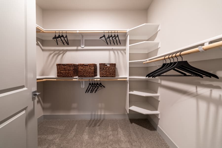 Walk-in closet in an apartment with shelving and hangers