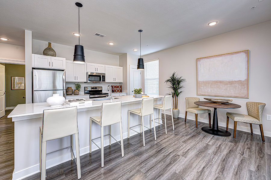 Kitchen with bar seating in a unit at Wheelhouse Apartments on the Monon